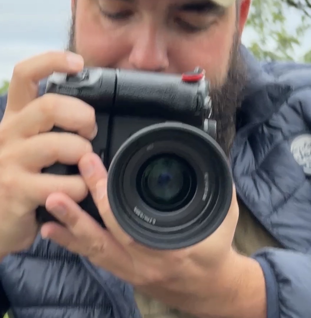 Reference photograph of the Sony camera, showing its red attachment loop